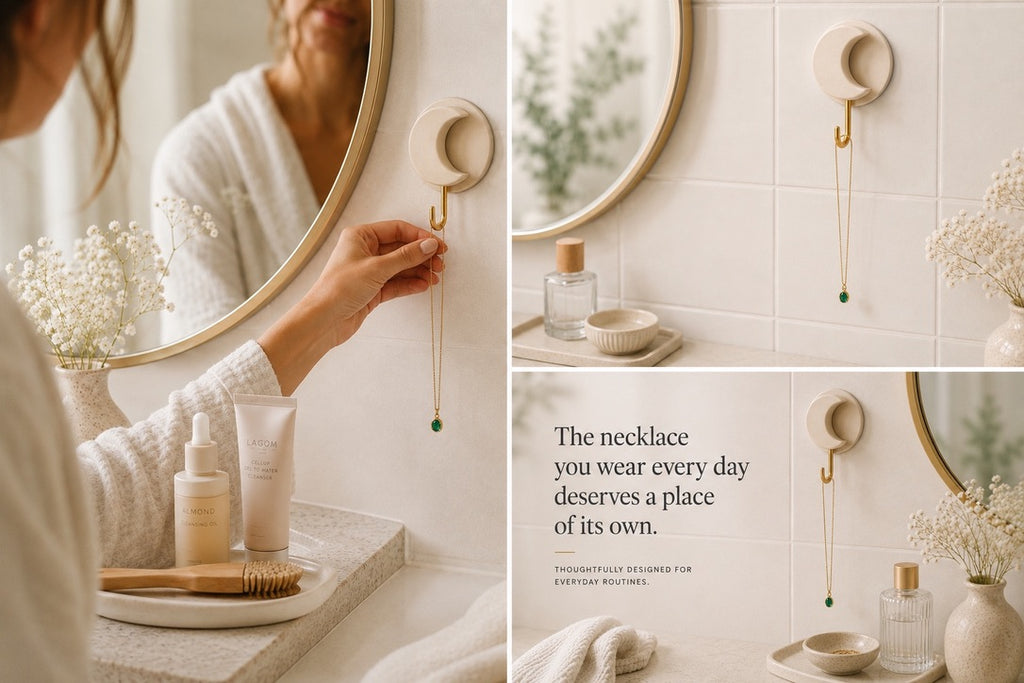 Woman placing a necklace on the Harperly Lune Hook beside a mirror